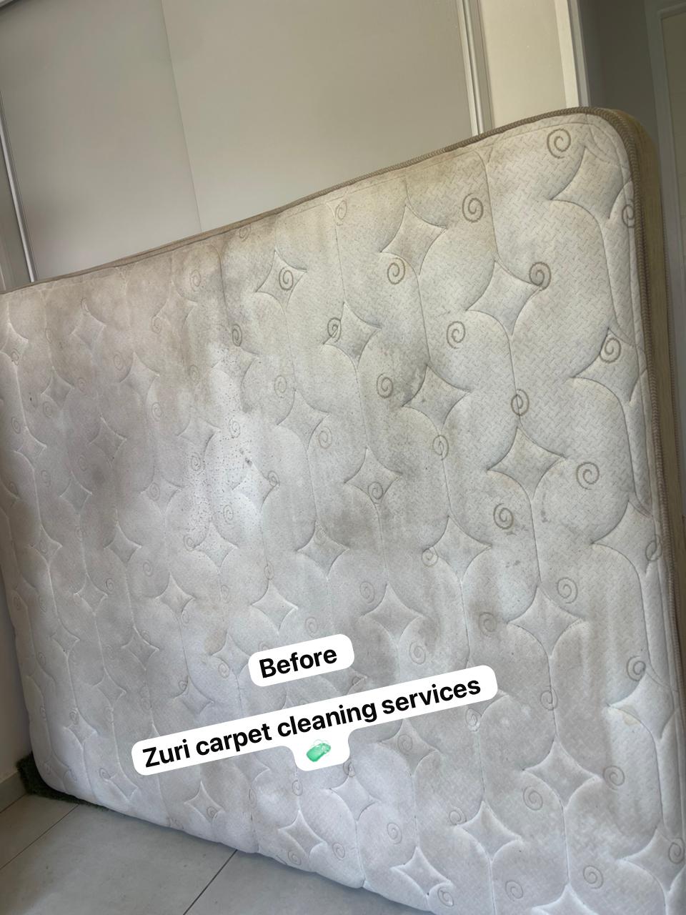 Mattress before a Zuri clean, showing dull fabric and soil.