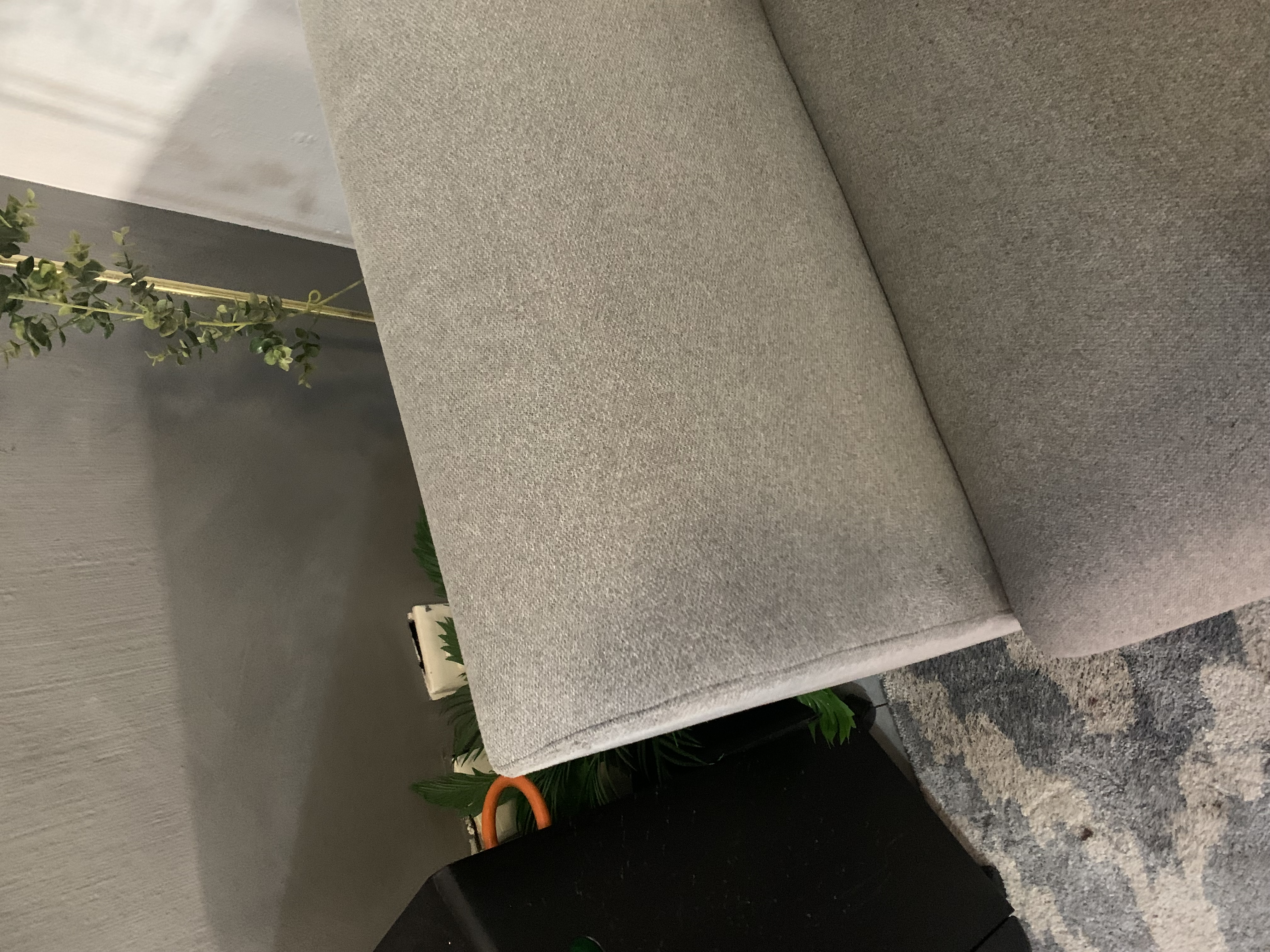 Close-up of freshly cleaned light grey upholstery after a Zuri home clean.